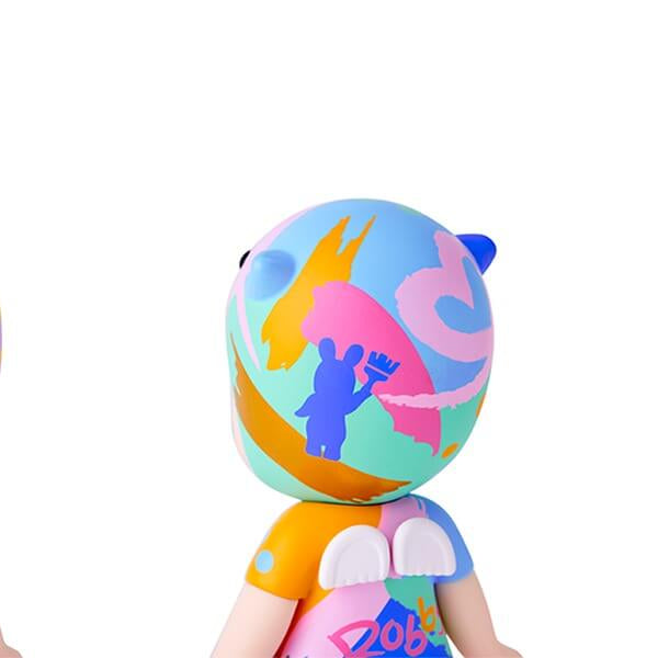 Colorful plush toy with abstract designs on a white background