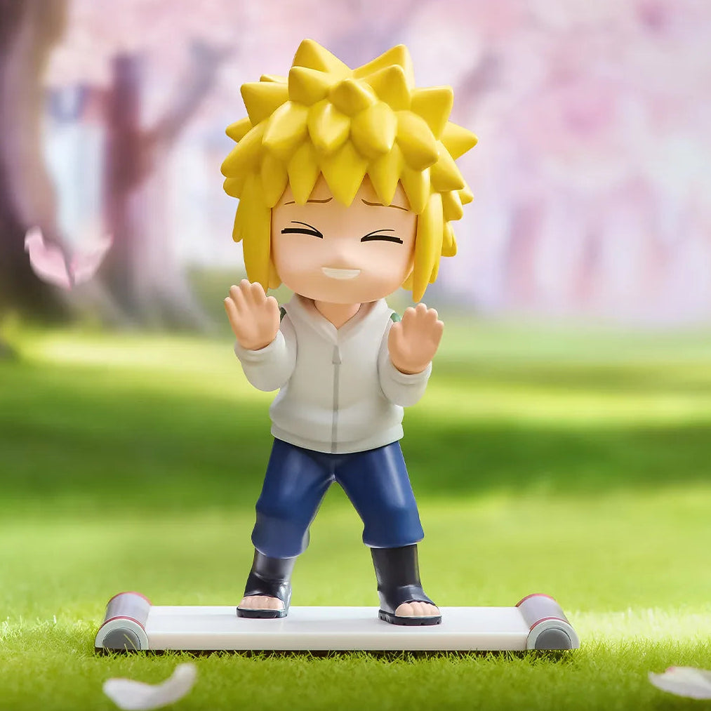 Figurine of a character with spiky yellow hair in a park with cherry blossoms