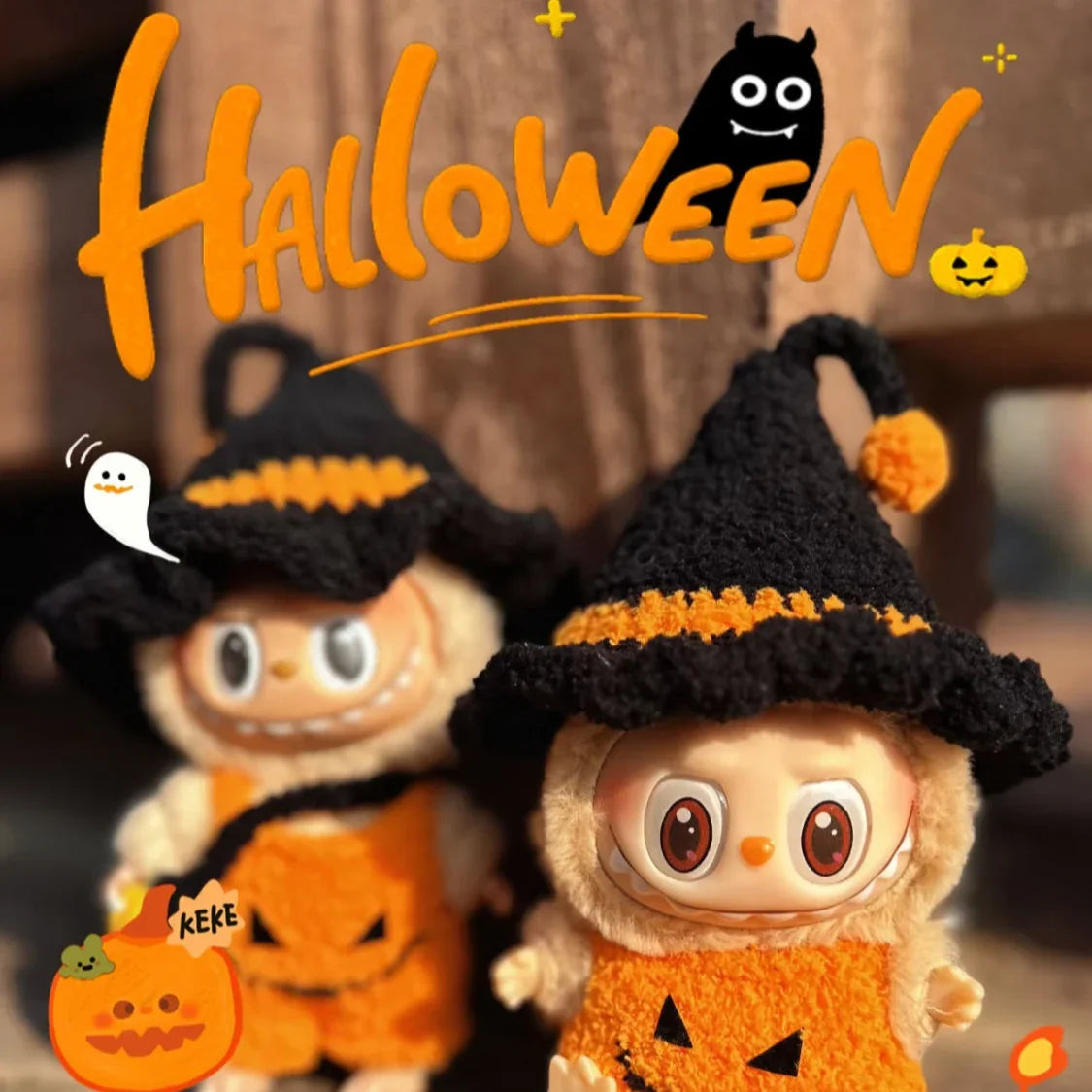 Two plush toys in Halloween costumes with pumpkins and ghost decorations, featuring the word 'Halloween'.