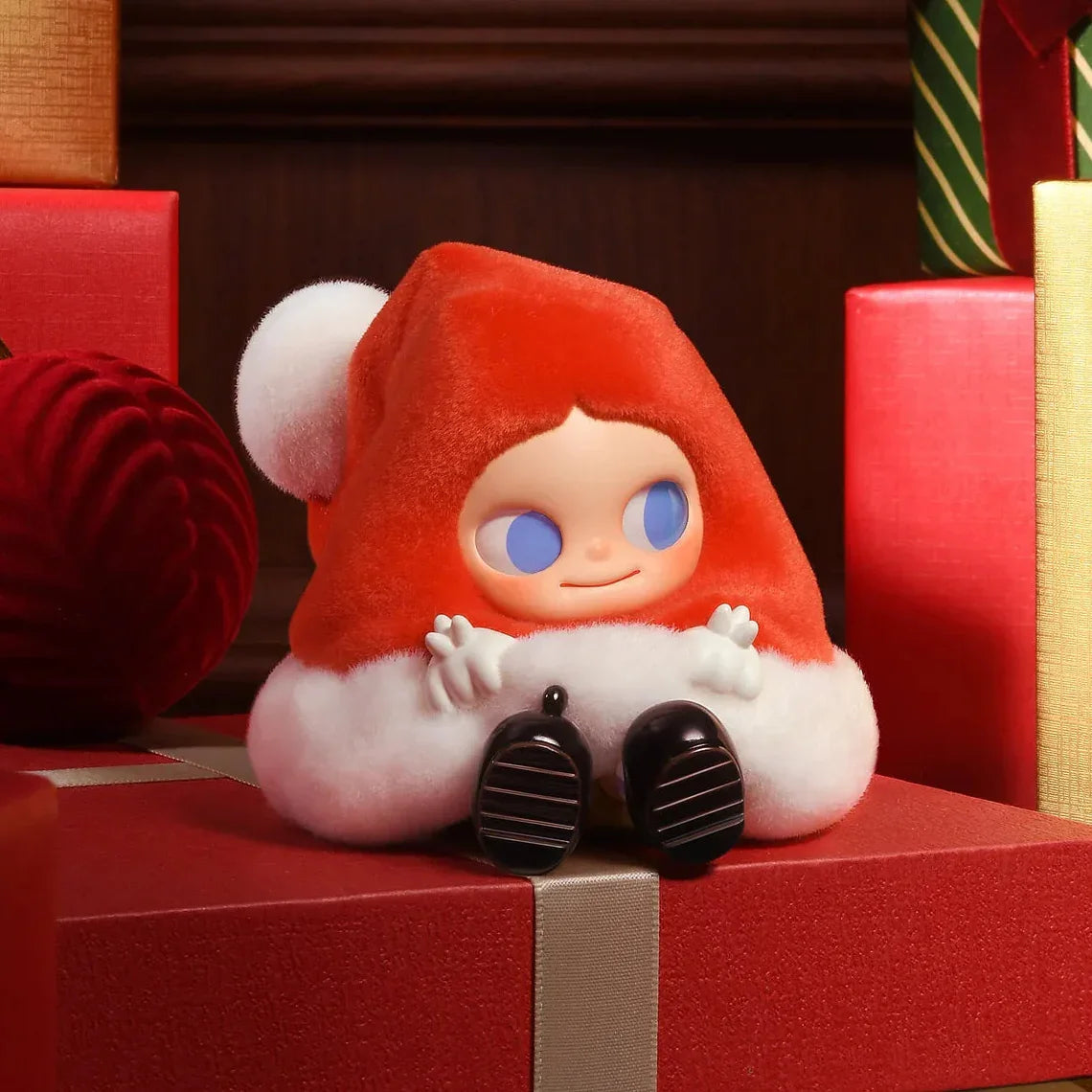Plush toy with a red hat and white outfit sitting on a red box, with text 'Hatful of Surprises' at the bottom.