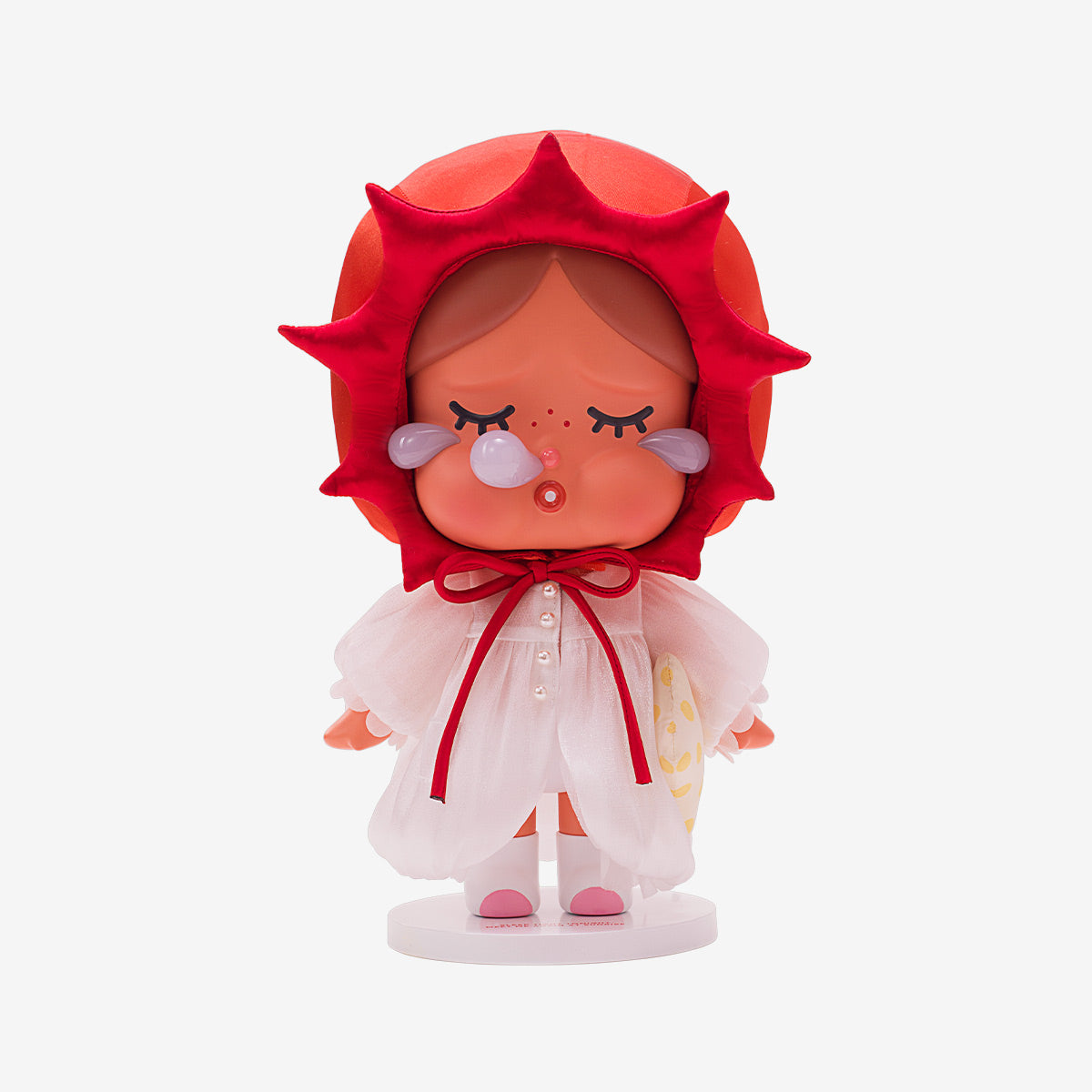 Toy figure with a red hood and white outfit on a white background