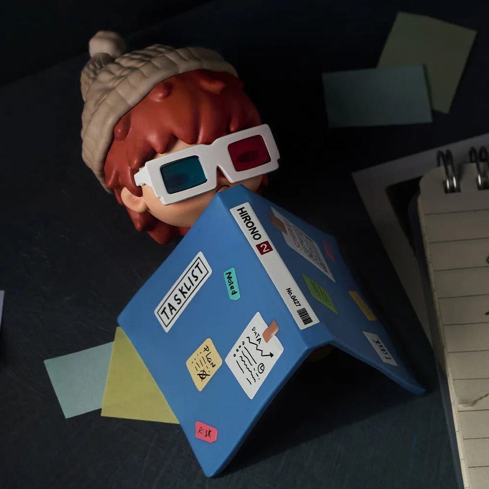 Figurine with 3D glasses on a folder labeled 'Camping' with scattered papers.