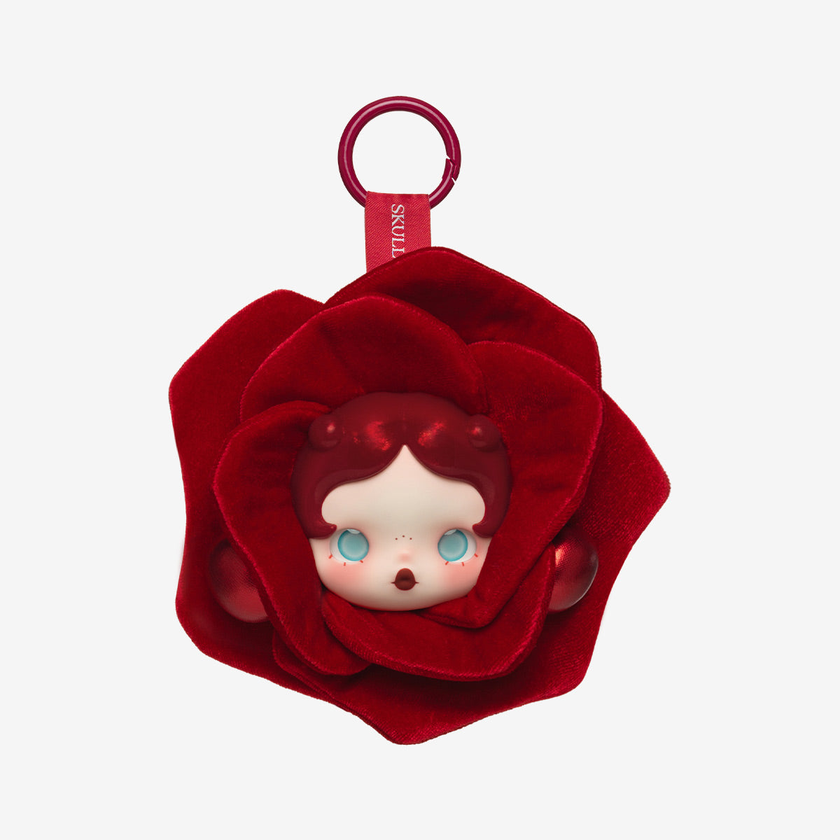 Red flower-shaped keychain with a character face inside on a white background