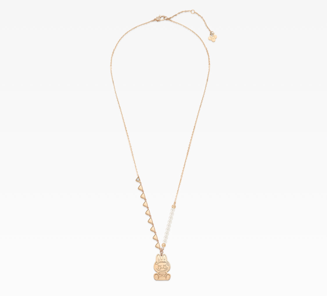 Gold necklace with a small pendant on a white background