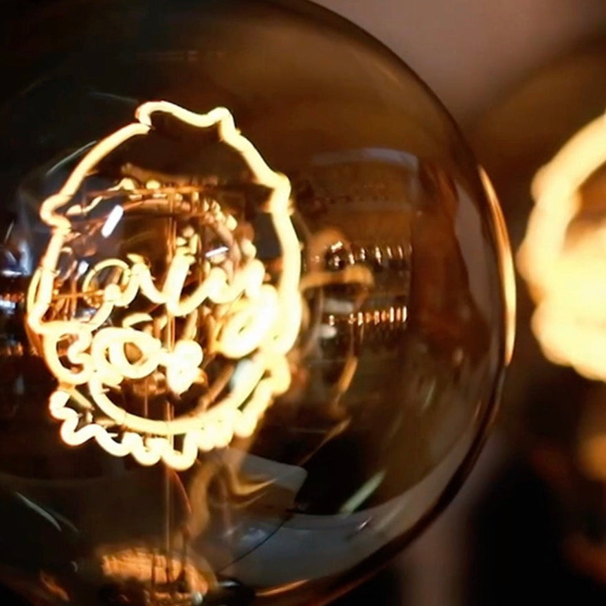 Close-up of a vintage light bulb with intricate design, blurred background