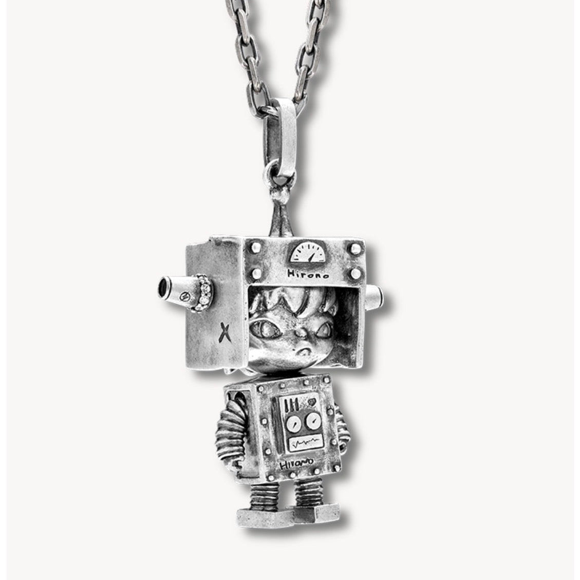 Silver robot pendant on a chain against a white background
