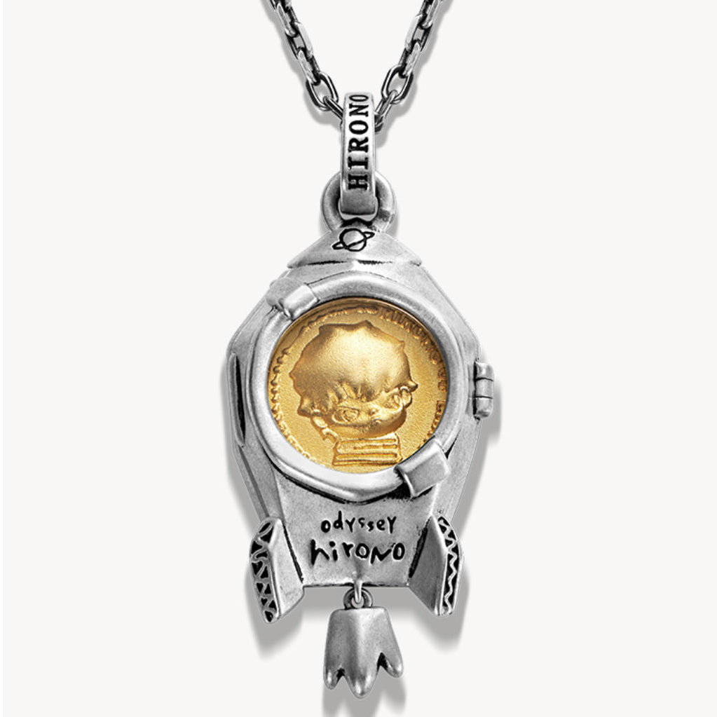 Silver pendant with a gold coin insert on a white background