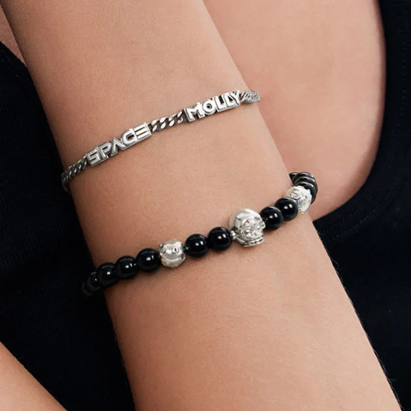 Bracelets on a wrist with visible brand name