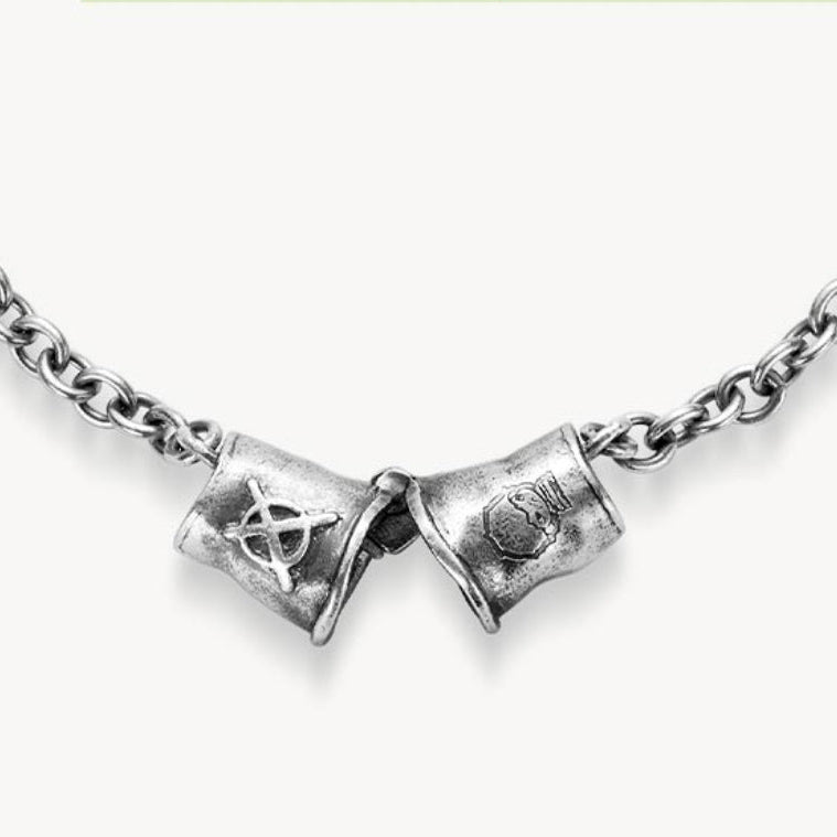 Silver necklace with two pendant elements on a white background