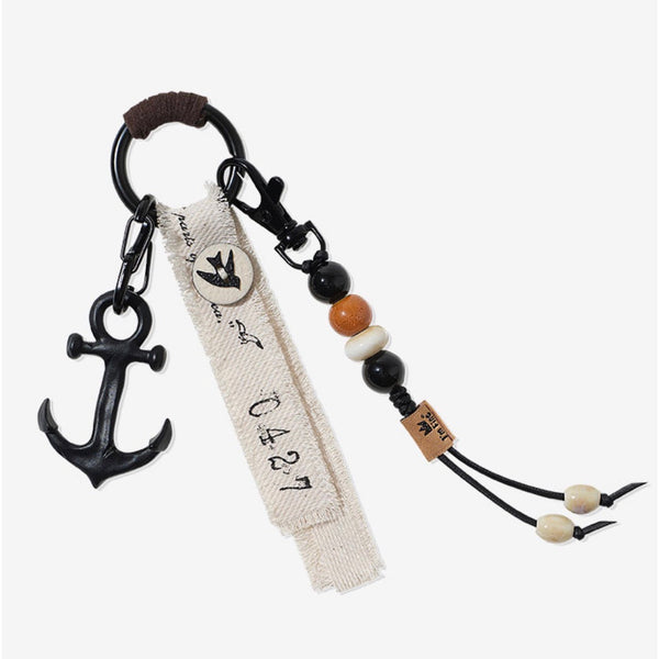 Keychain with anchor charm and decorative beads on a white background
