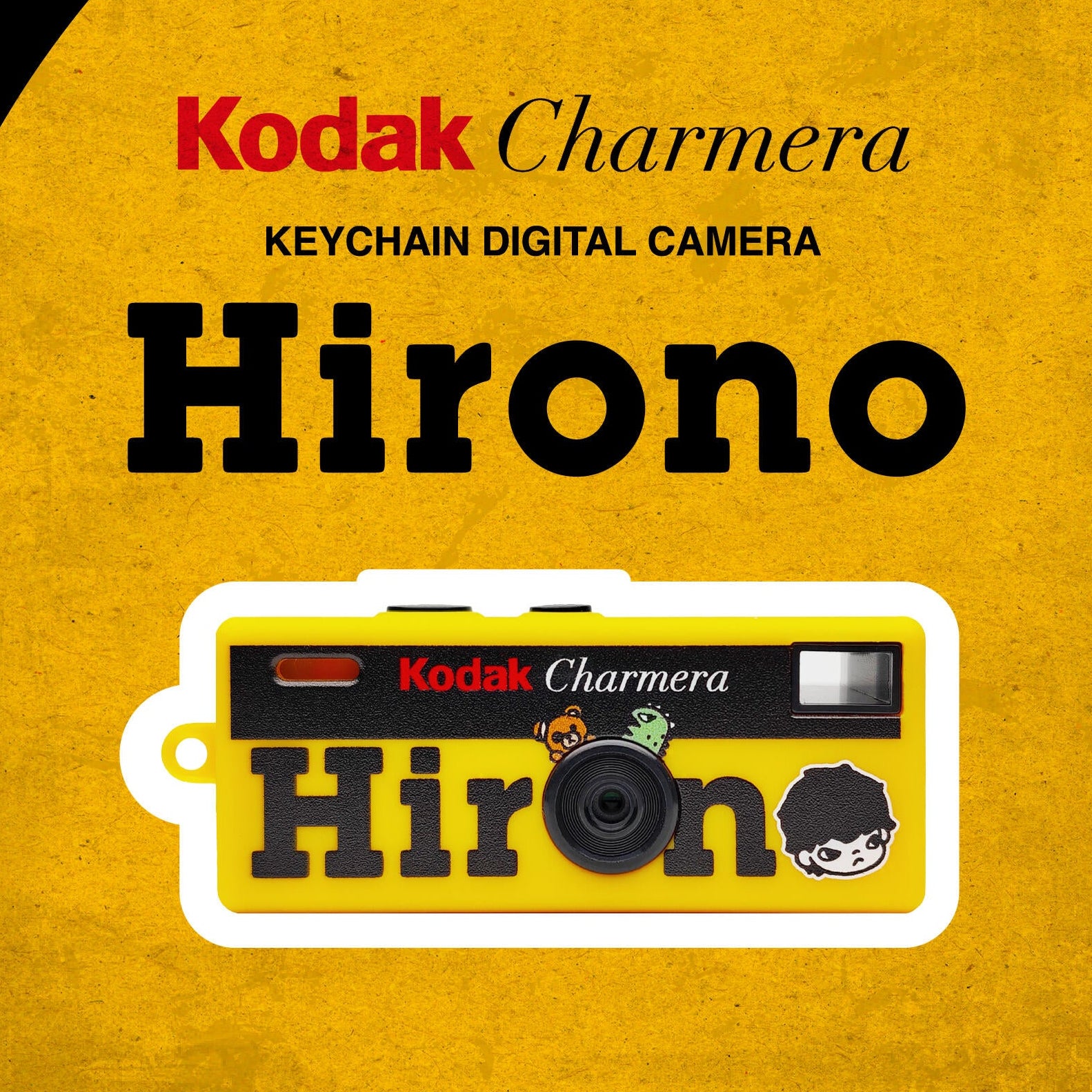 Kodak Charmera Hirono keychain digital camera poster on a textured yellow background with a black and red graphic header, featuring the product illustration and branding.