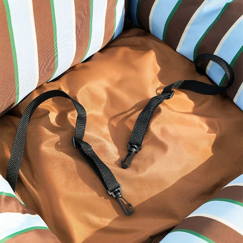 Brown fabric with black straps on a striped background