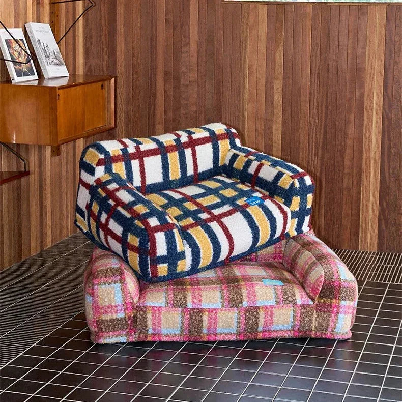 Colorful checkered pet bed on a tiled floor with wooden walls.