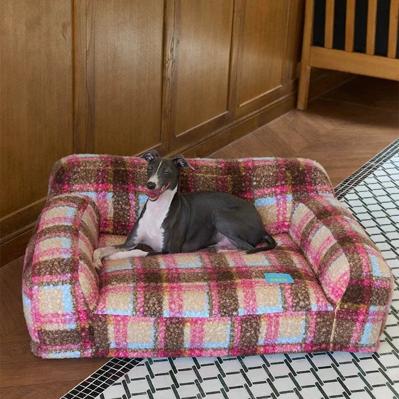 Dog lying on a checkered pet bed in a room with wooden walls.