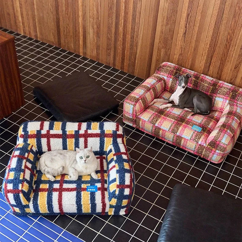 Two pet beds, one plaid and one checkered, with cats inside on a tiled floor.