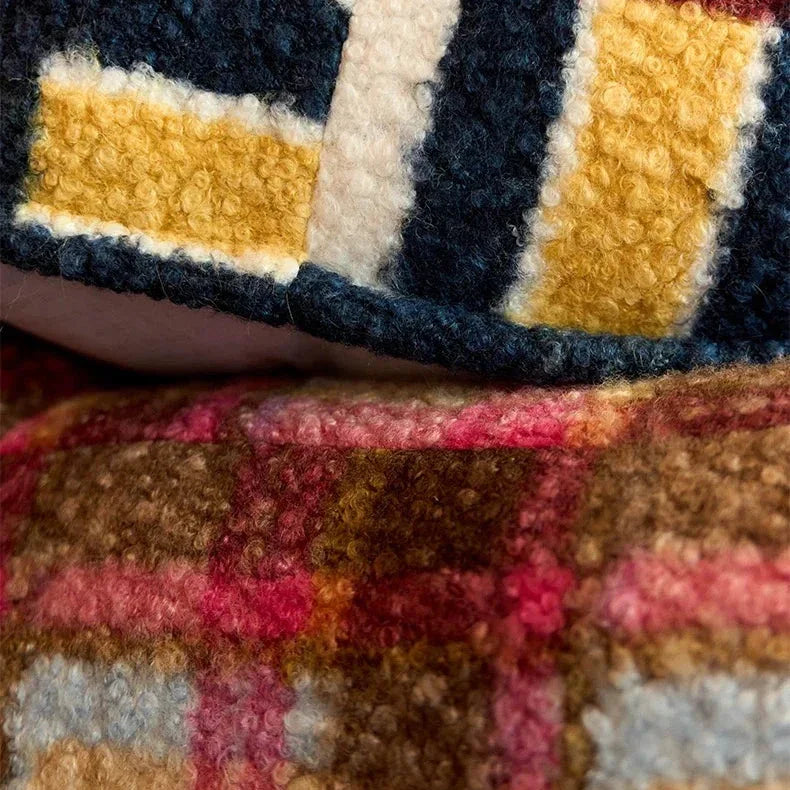 Close-up of a textured, multicolored fabric with geometric patterns.