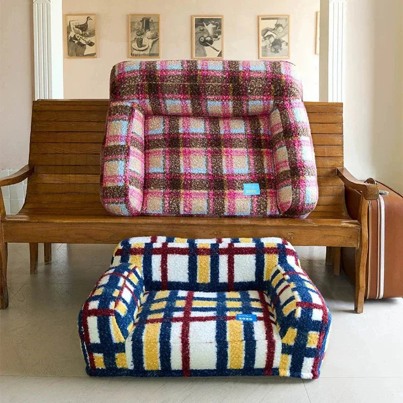 Wooden bench with plaid cushions in a room with decorative elements.