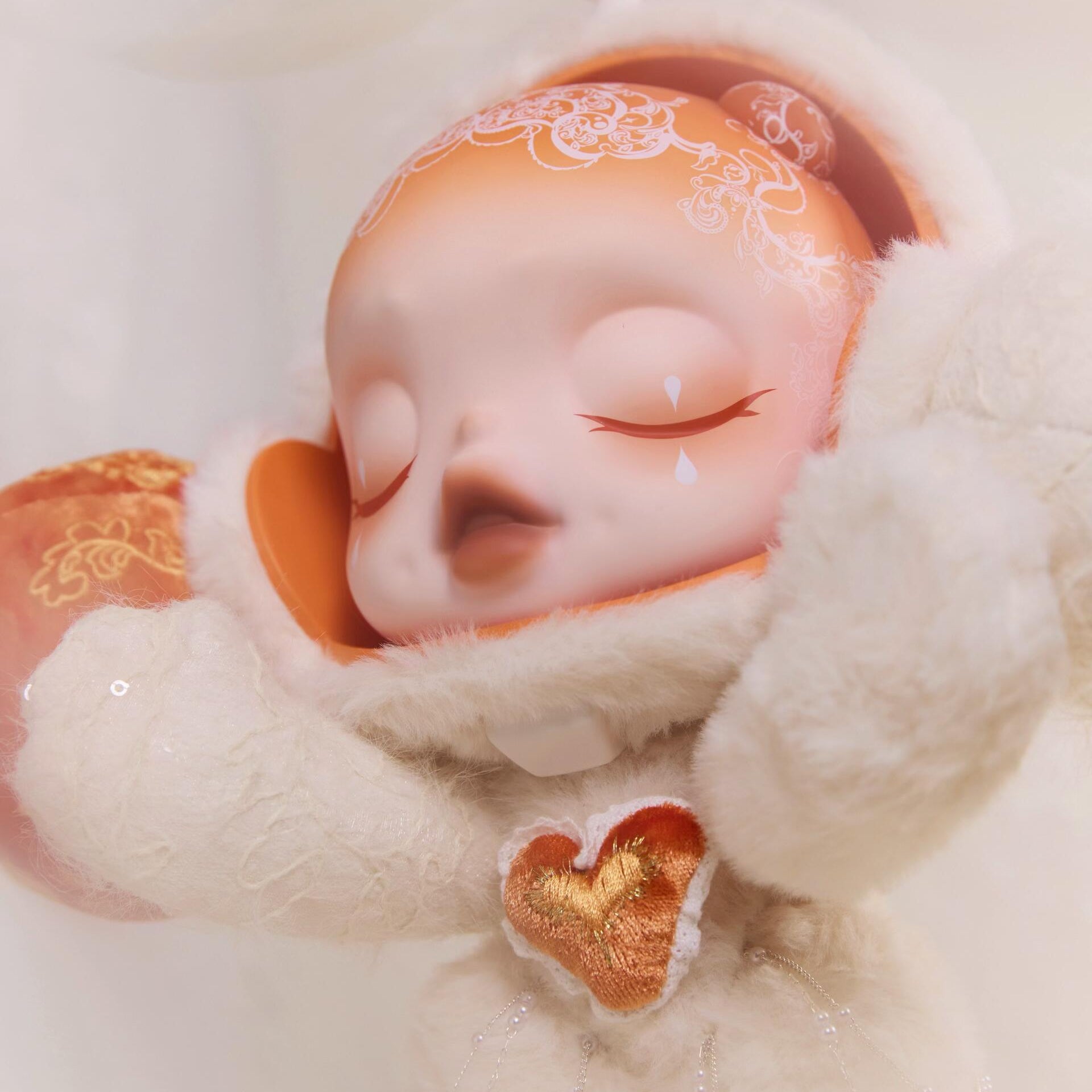 Close-up of a SKULLPANDA Doll with closed eyes, wearing a decorative headband and holding a heart-shaped object.