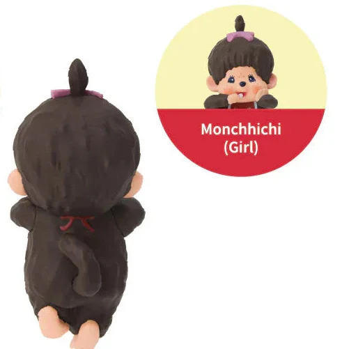 Monchhichi doll, girl, with label indicating  gender on a white background.