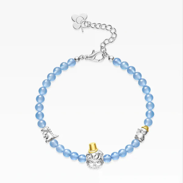 Bracelet with blue beads and decorative charms on a white background