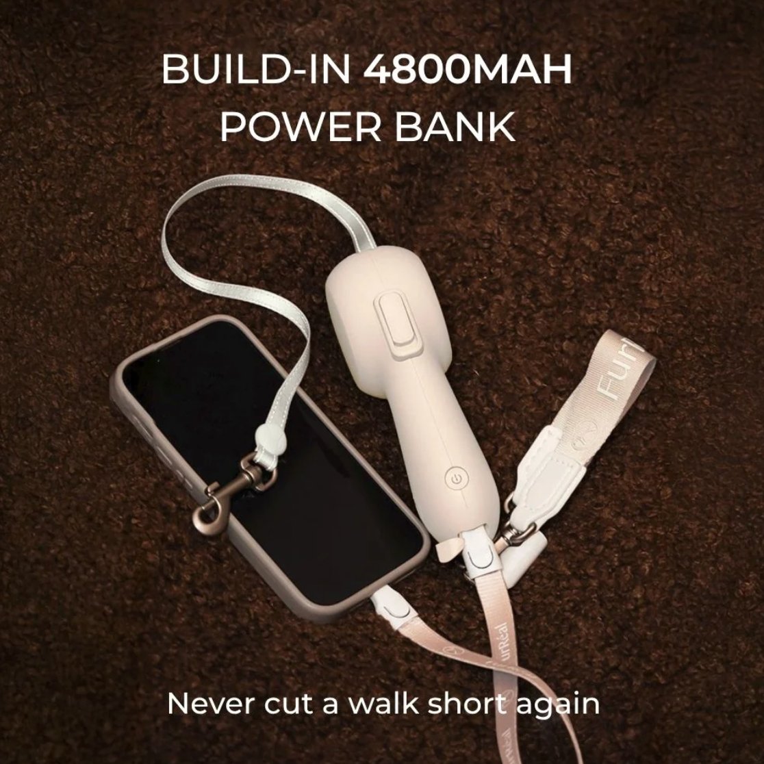 A beige built-in power bank with a wrist strap and metal clip, shown connected to a smartphone on a dark brown textured background. Text overlays read 'BUILD-IN 4800MAH POWER BANK' and 'Never cut a walk short again'.