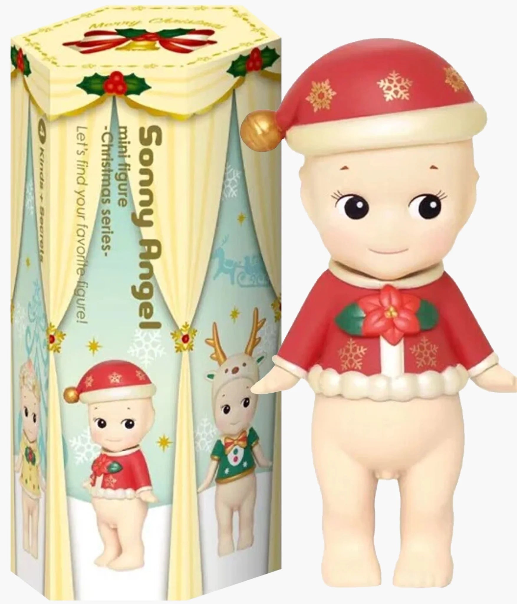 A Sonny Angel Christmas-themed figurine shown next to its illustrated retail box. The figurine is a baby character wearing a red Santa hat with gold snowflakes, a red holiday sweater with a green rose, and cream-colored skin and trim.