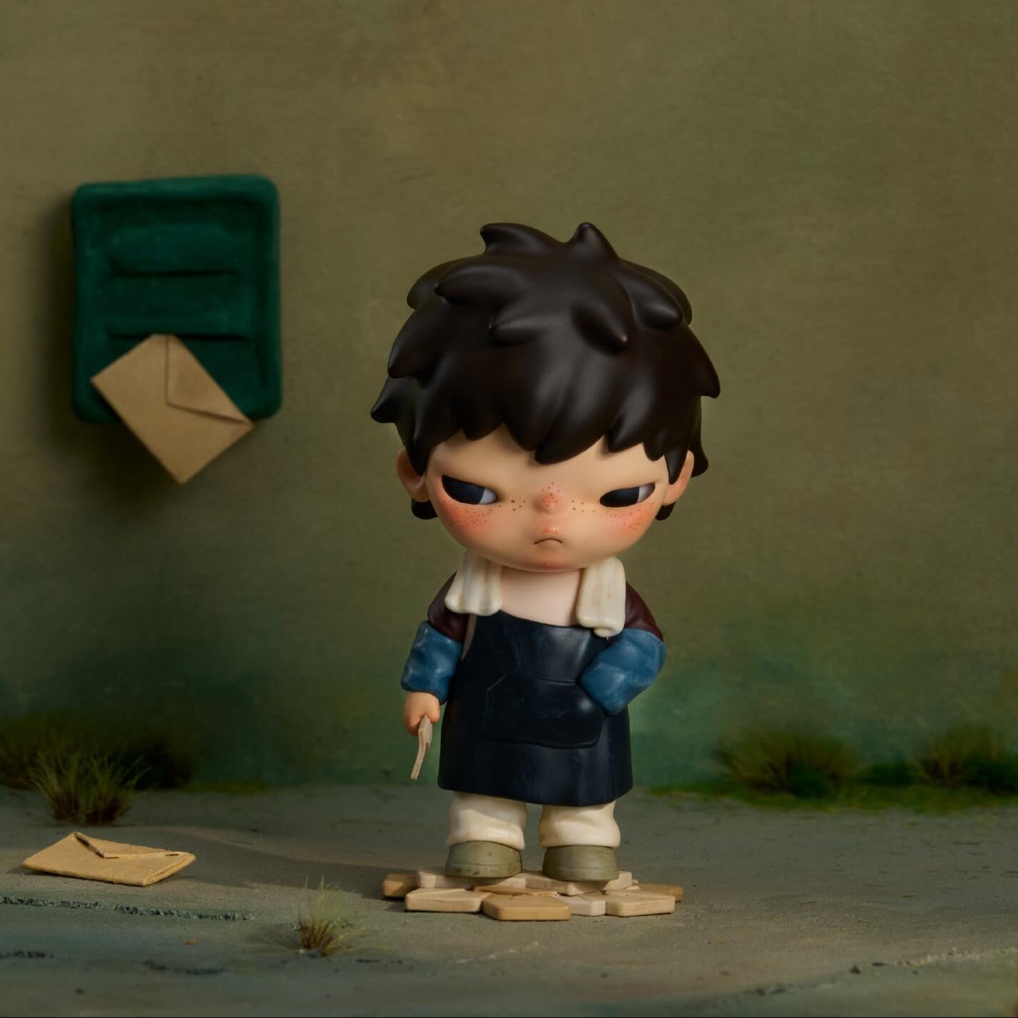The Fleeting Years — Hirono x Wuzhen Collaboration Exclusiveof a child standing in front of a mailbox with a letter attached, on a textured green background.