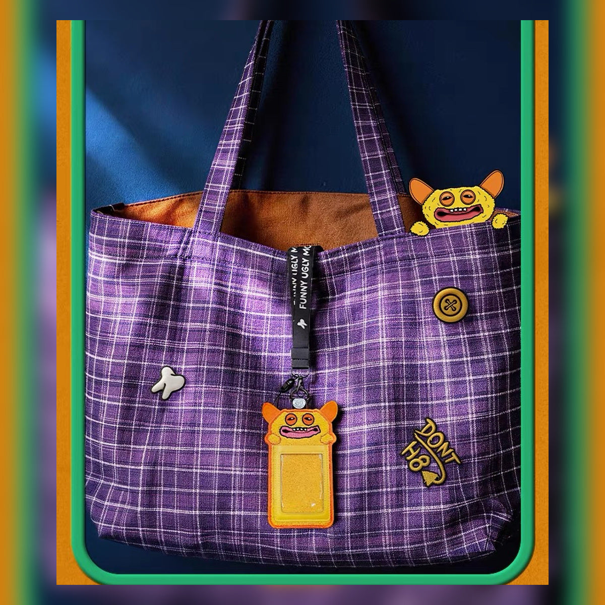 Fuggler Big Laugh Monster ID card holder clipped to a tote bag