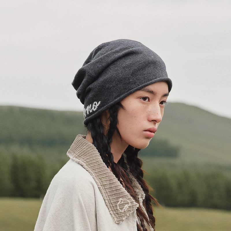 Model wearing POP MART HIRONO Whisper Within charcoal gray slouchy beanie