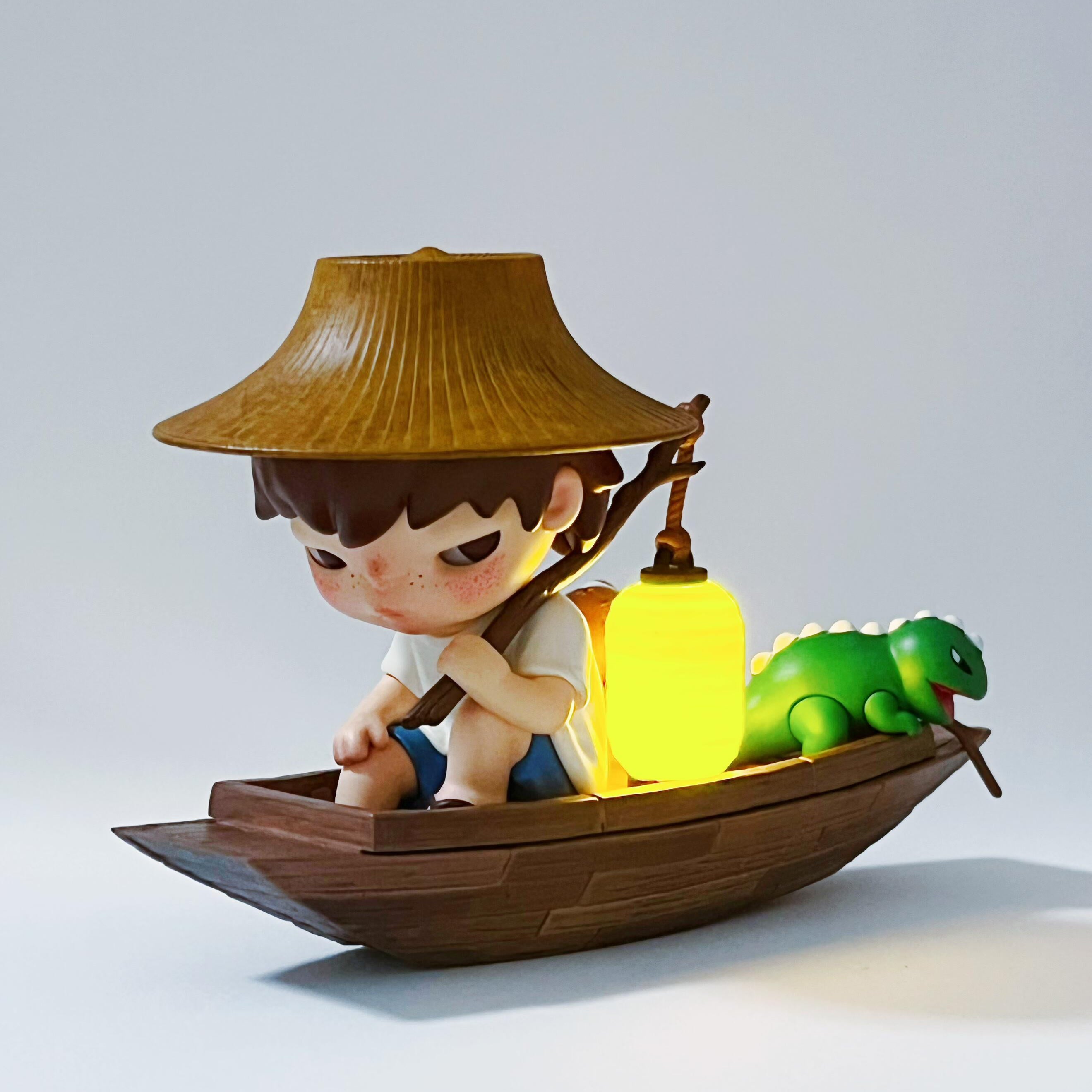 hirono floating market Figurine of a boy with a hat on a boat holding a glowing lantern, with a green creature beside him, on a light gray background.