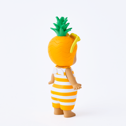 Two toys, one resembling a baby with a pineapple hat and another resembling a pineapple with a baby in a striped outfit, on a white background.