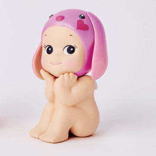 Three baby figurines with pink hair and bunny ears on a white background