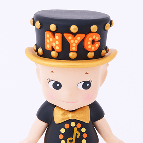 Two figurines wearing black outfits with 'NYC' hats on a white background