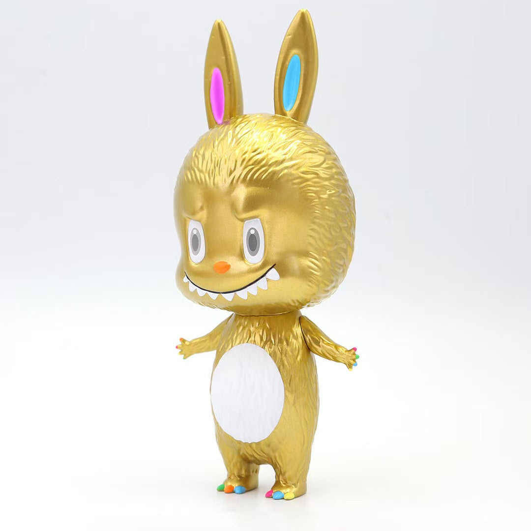 Gold labubu figurine with colorful accents on a white background