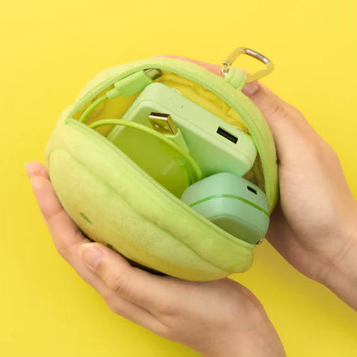 Green spherical case with wireless earbuds on a yellow background