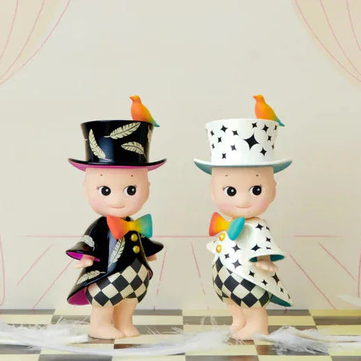 Two toy figures in colorful outfits with top hats on a checkered floor.