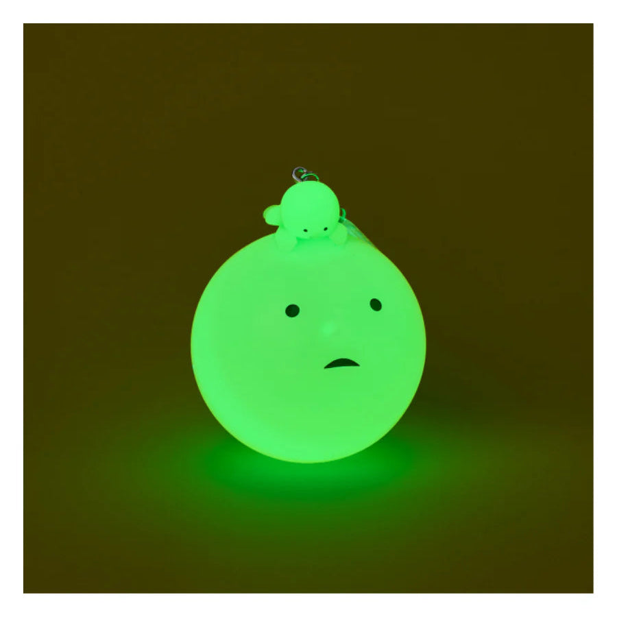 Glowing green character on a dark background