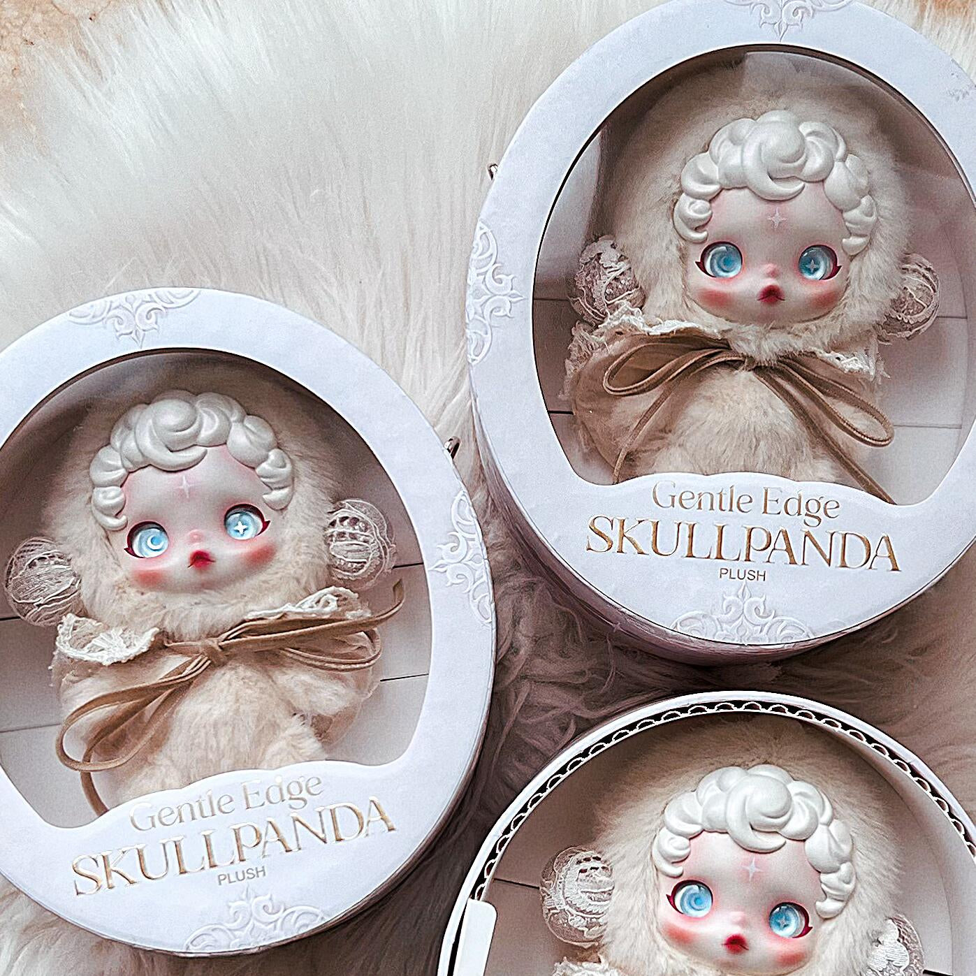 Three identical skullpanda gentle edge small dolls in decorative boxes on a soft white background