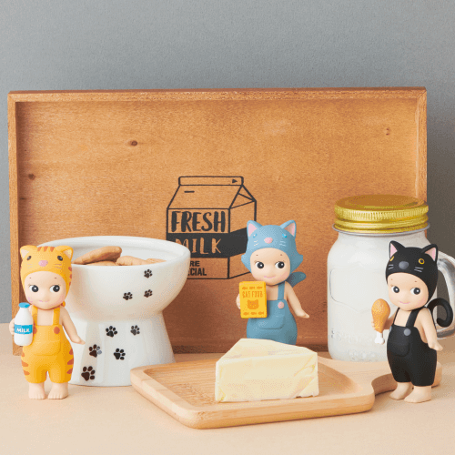 Set of small animal figurines with a wooden box and cat tree in the background